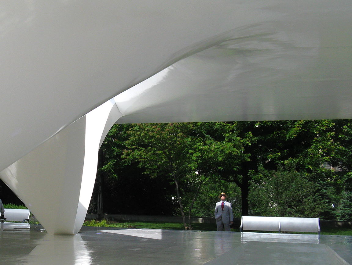 Dapper man in white suit contemplates vanilla ice cream scoops pavilion (Burnham Pavilion, Millennium Park, UN Studio)